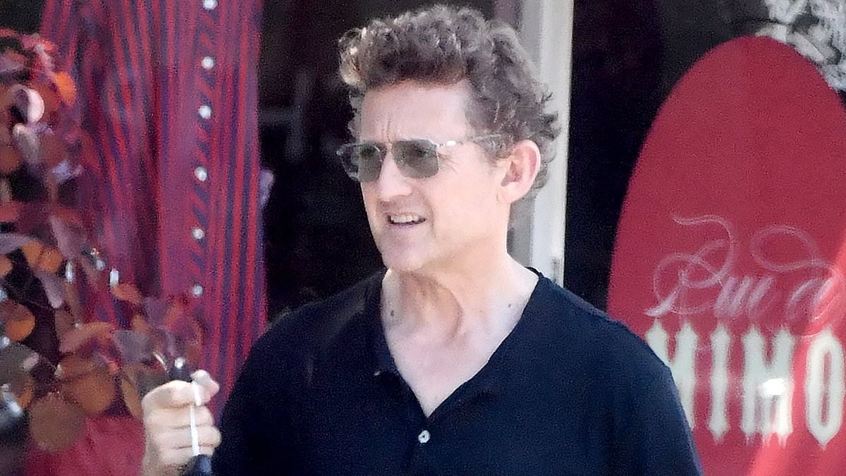 EXCLUSIVE Iconic '80s star looks shockingly youthful on his 60th birthday during rare outing... can you guess who it is?