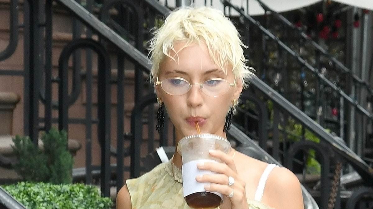 Iris Law puts on a VERY leggy display in a semi-sheer floral mini dress as she steps out in New York City