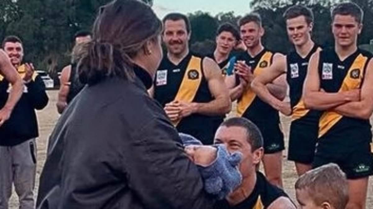 Footy star celebrates 200th game milestone with proposal for the ages -'had to make sure we got the win first'