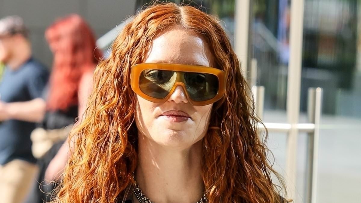 Jess Glynne flashes her abs in a tiny black bralet and edgy denim jeans as she soaks up the London sunshine
