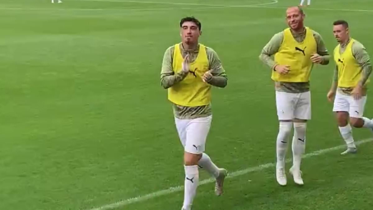 Oldham striker Kian Harratt waves and applauds fans after they chant his name weeks after his involvements in Ibiza poolside brawl