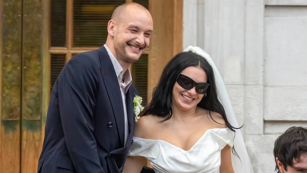 BREAKING NEWS Charli XCX is married! Brat singer stuns in a leggy white mini dress and her trademark shades as she puts on a VERY saucy display with The 1975 star husband George Daniel