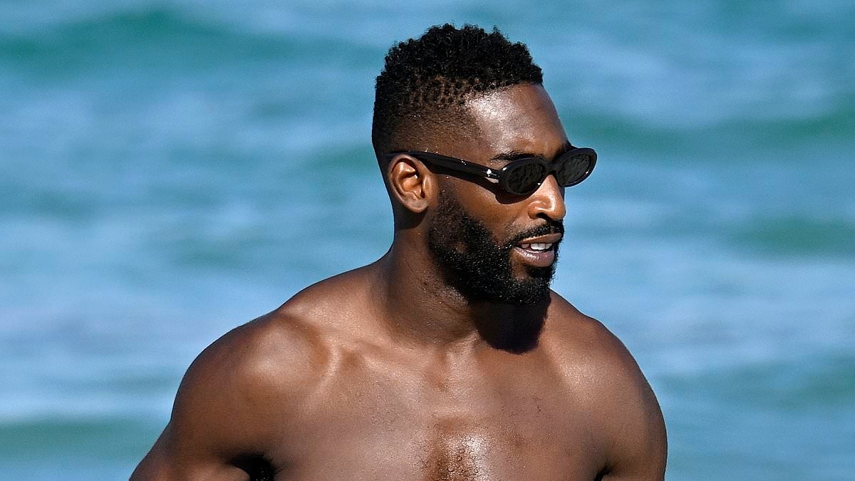 Shirtless Tinie Tempah displays his muscular physique on the beach in Mallorca ahead of Love Island appearance - as he prepares for musical comeback
