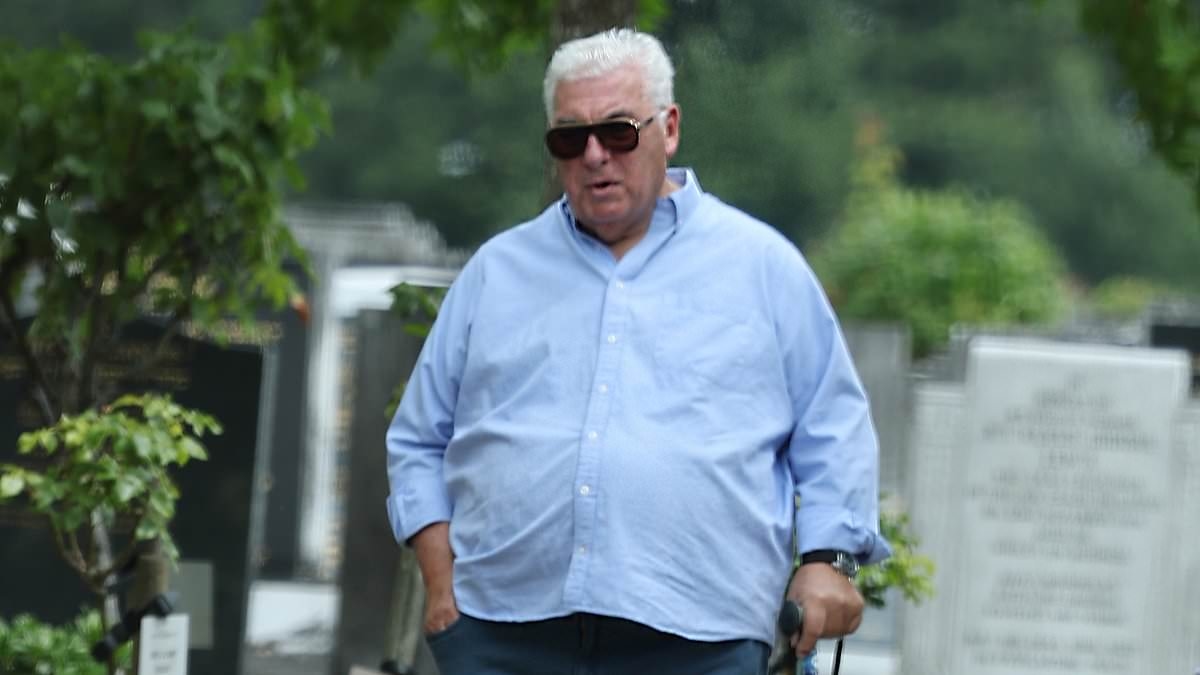 Amy Winehouse's parents Mitch and Janis appear emotional as they visit her grave on the 14th anniversary of her death