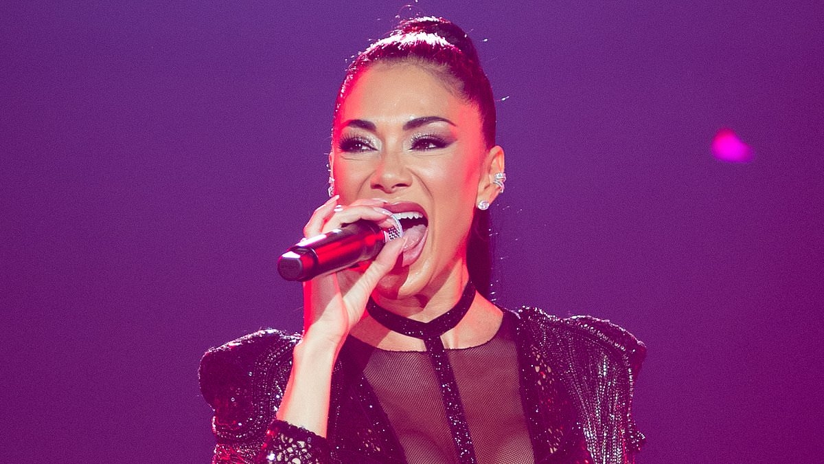 Nicole Scherzinger puts on a racy display in a sheer lace catsuit as she models TWO stylish looks while attending Dream Fest in Baku