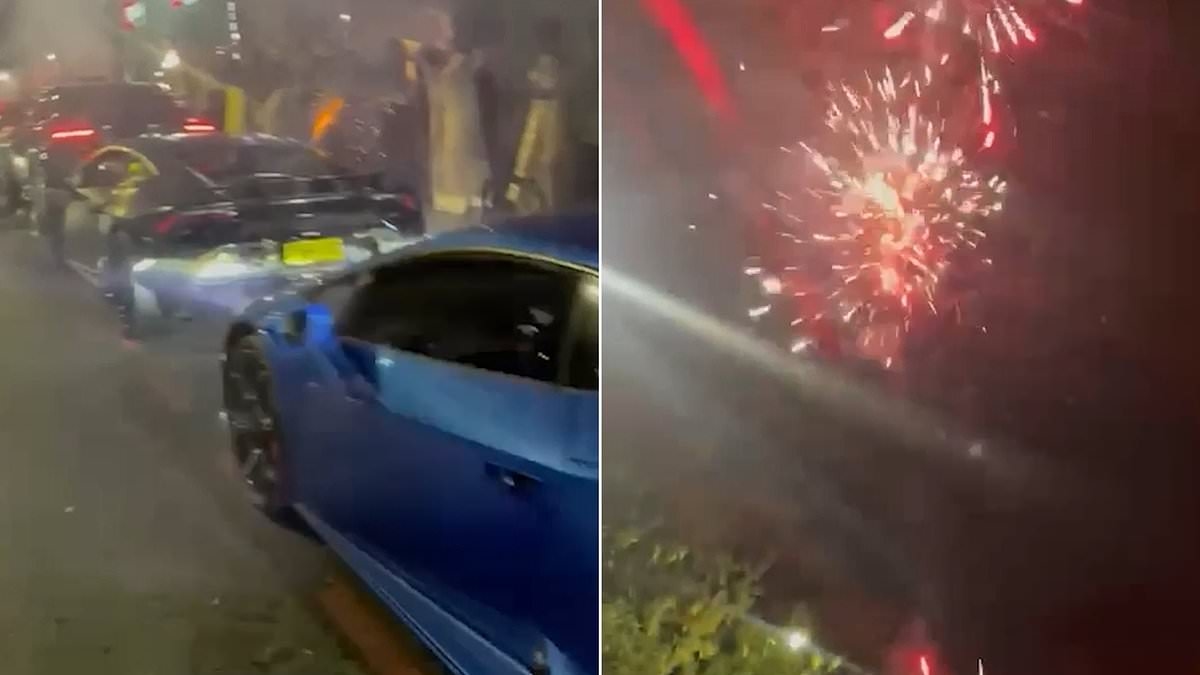 Moment yobs block off London street with fleet of supercars and set off fireworks in the middle of the road at midnight during 'wedding celebration'