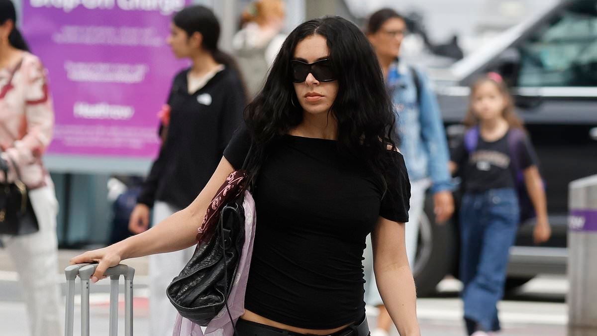 Charli XCX arrives at Heathrow Airport without her new husband George Daniel just days after tying the knot in lavish London ceremony