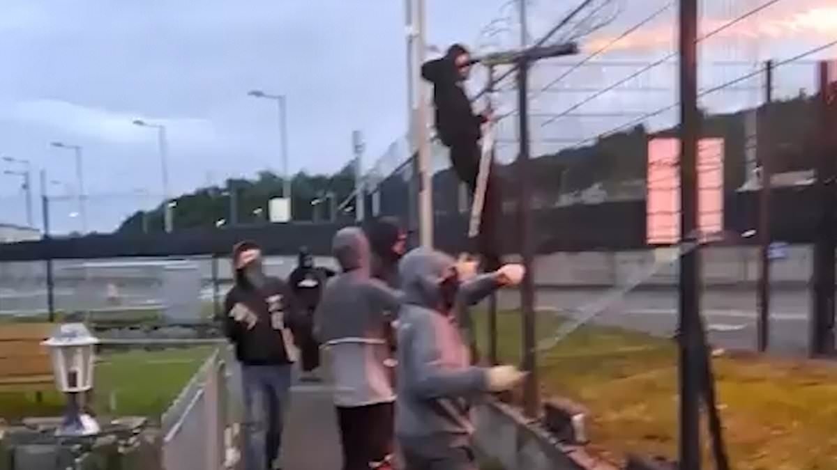 Horrifying moment football hooligans blast their rivals with fireworks and attack each other with sticks