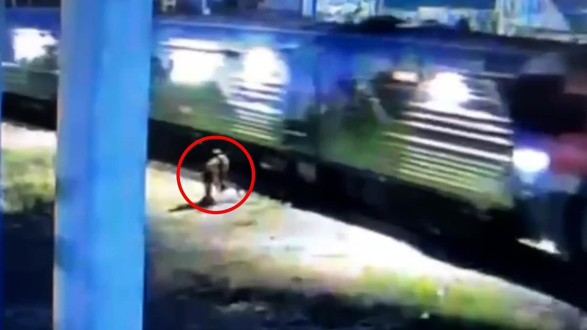 Incredible moment hero dashes in front of train just in time to save man who collapsed on track