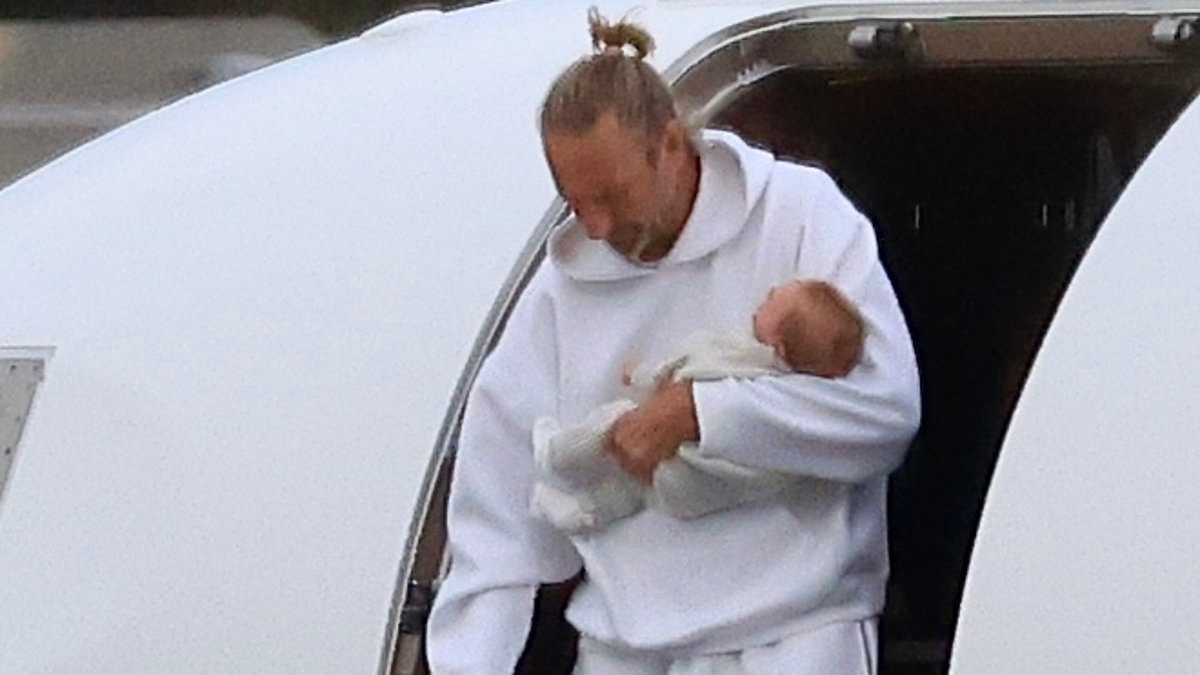Billionaire pub baron Justin Hemmes touches down in Sydney with his newborn son and girlfriend Madeline Holtznagel after family holiday