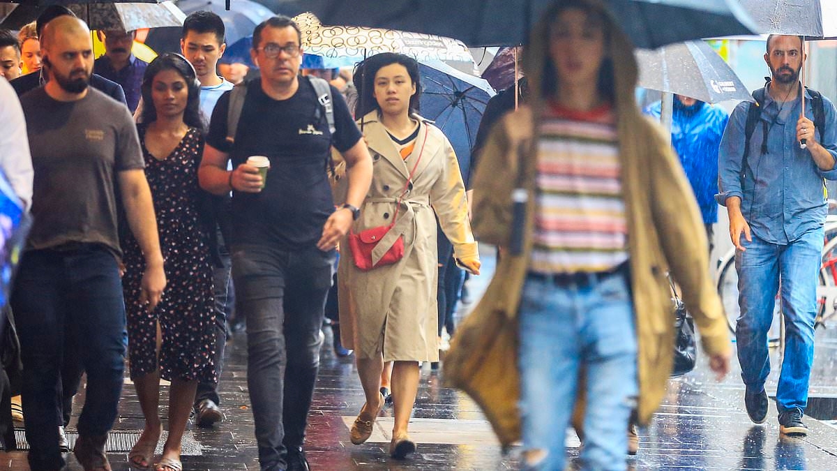 Rain bomb alert as mammoth weather system moves across Australia and temperatures plunge - as city records wettest day of the year