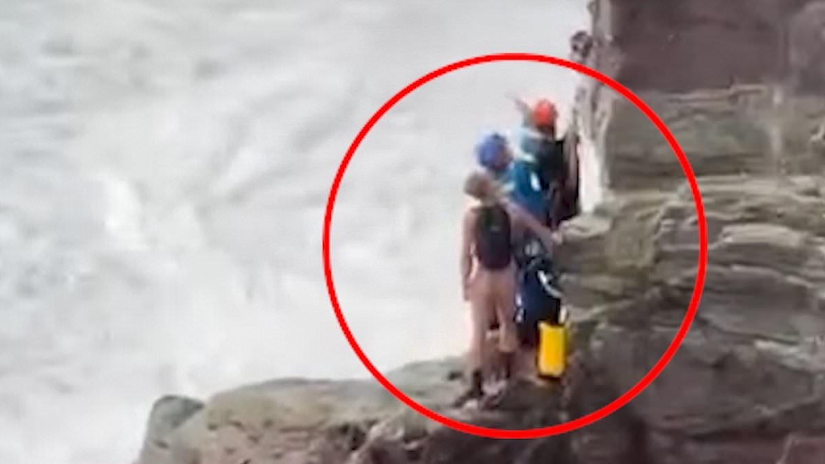 Dramatic moment coastguards abseil down Cornwall cliff face in daring rescue operation to save two people cut off by the tide