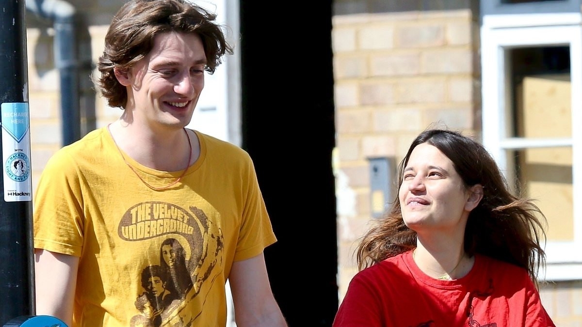 Tiger Lily Hutchence and her husband Ben Archer dote on their newborn baby as they enjoy a family stroll in London