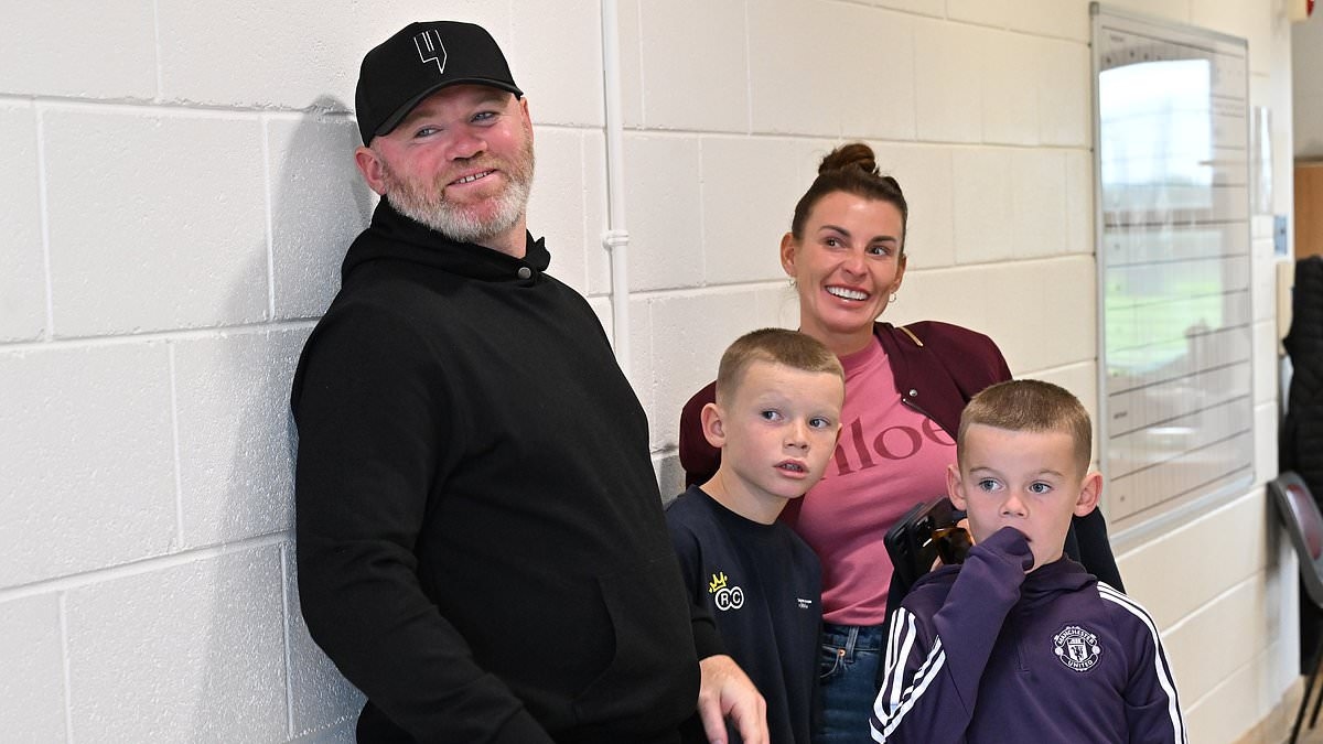 Supportive parents Wayne and Coleen Rooney watch their son Kai, 15, play for Manchester United in the Super Cup NI as he follows in his father's footballing footsteps