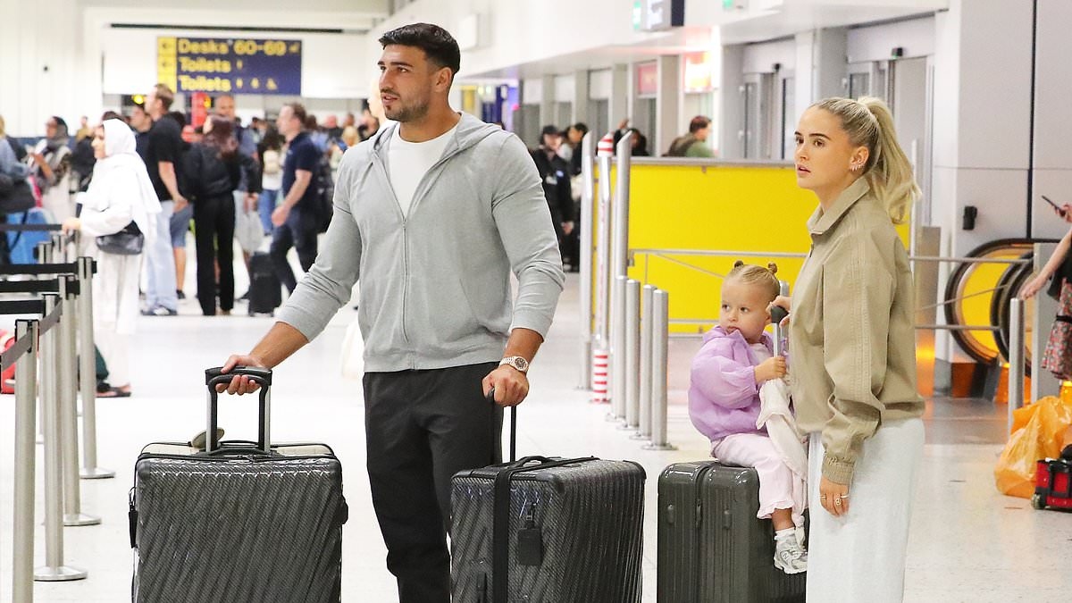 Molly-Mae fails to raise a smile as she prepares for Jet2 flight with Tommy Fury and daughter Bambi - after being labelled 'out of touch' for claiming she 'hasn't done one fun thing' all summer (despite spending much of it abroad)