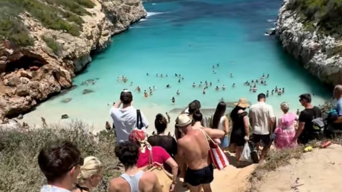 The 'secret' Spanish paradise beach ruined by influencers: Videos show piles of rubbish and tourists queuing to reach sand at Majorca beauty spot lauded by Instagrammers