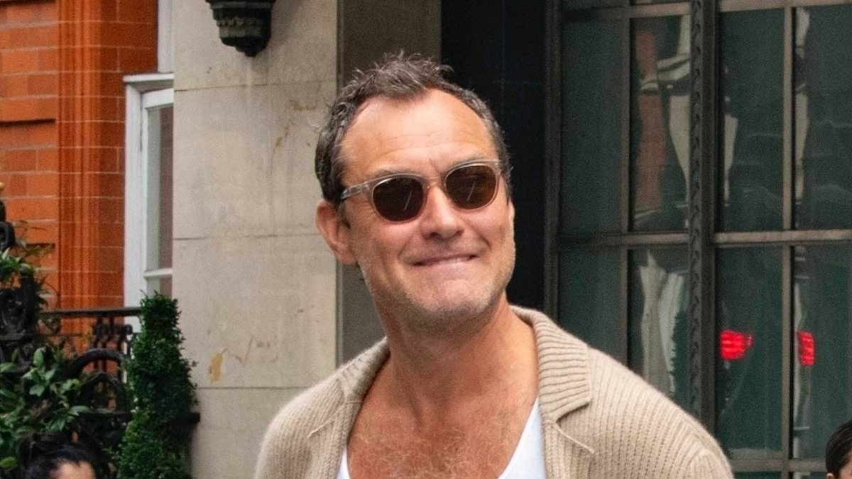 Jude Law, 52, cuts a trendy figure in a beige knitted cardigan and white linen trousers as he steps out to meet pals
