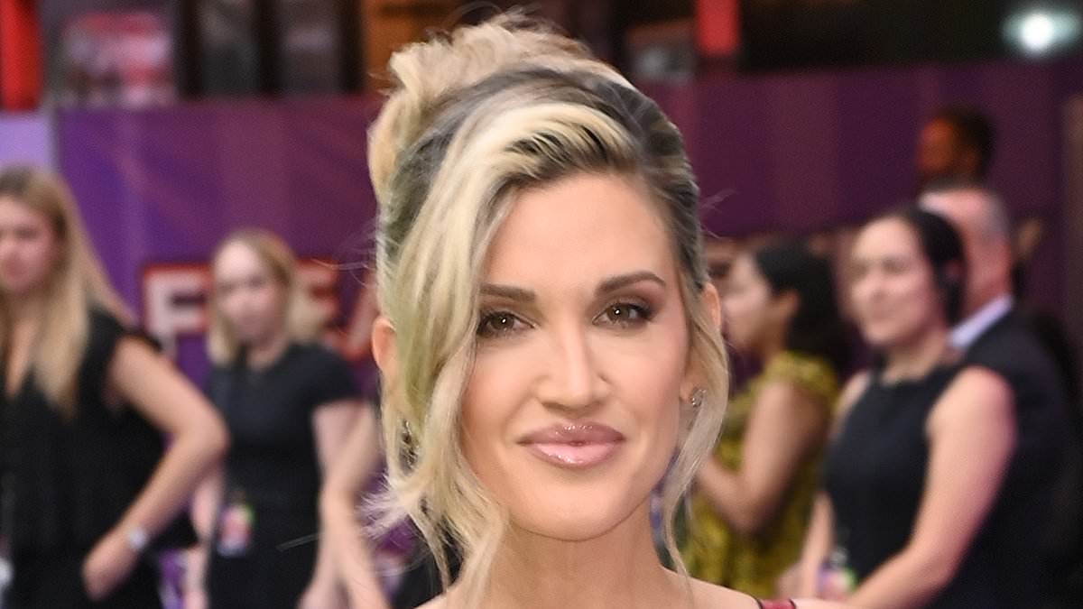 Ashley Roberts takes inspiration from Madonna's famous conical bra as she slips into a figure-hugging red satin dress for the UK premiere of Freakier Friday