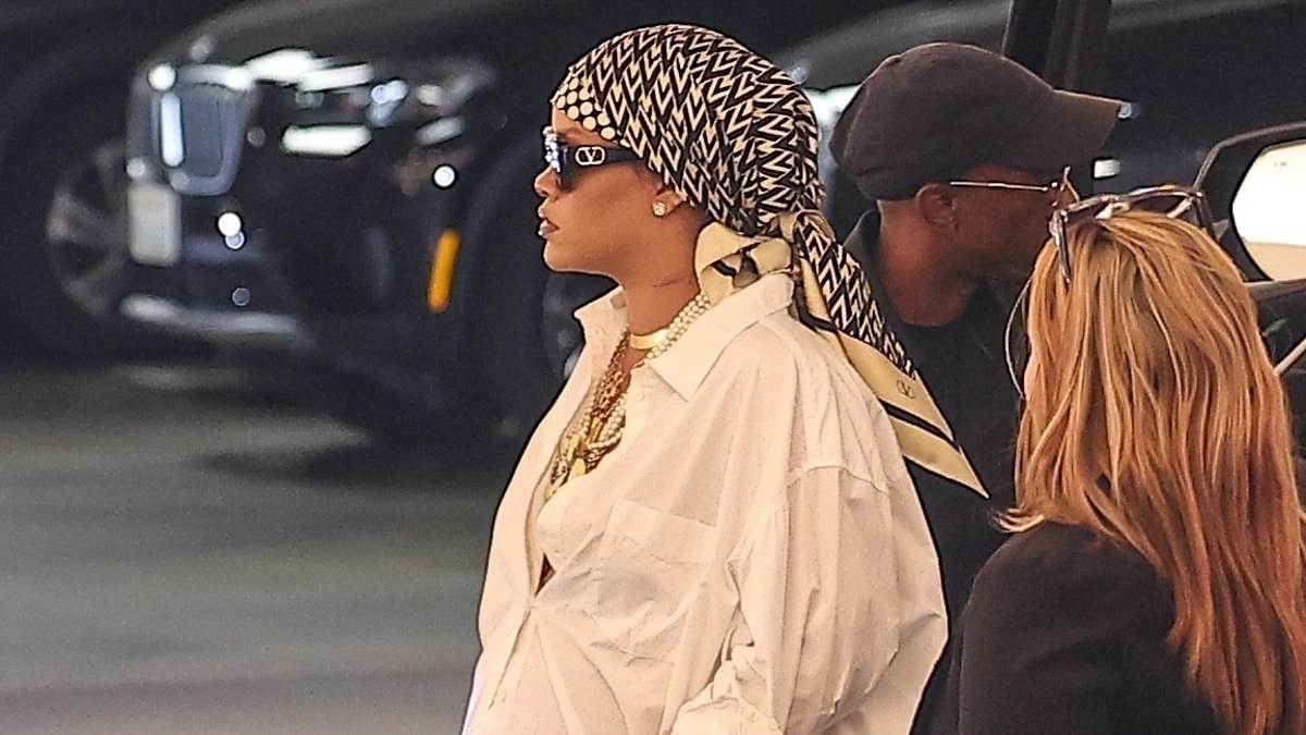 Pregnant Rihanna covers her growing baby bump with a white shirt during outing in Beverly Hills as she prepares to welcome her third child