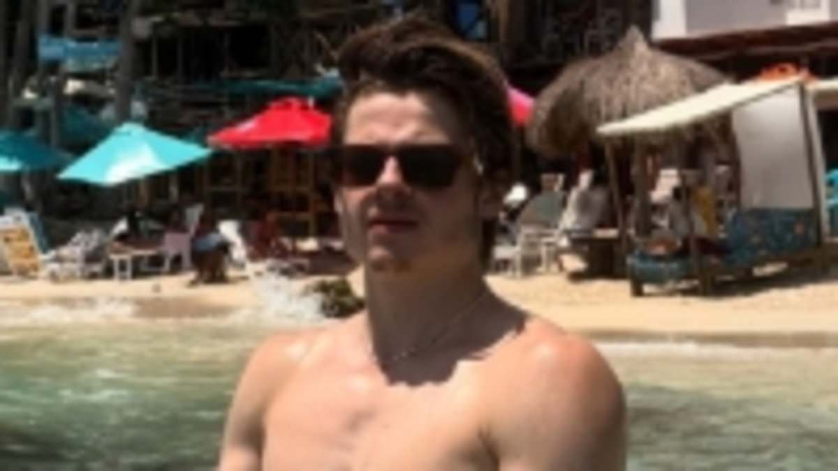 Hollywood star's nepo baby son reveals ripped torso and bulging biceps while on holiday with his stunning girlfriend