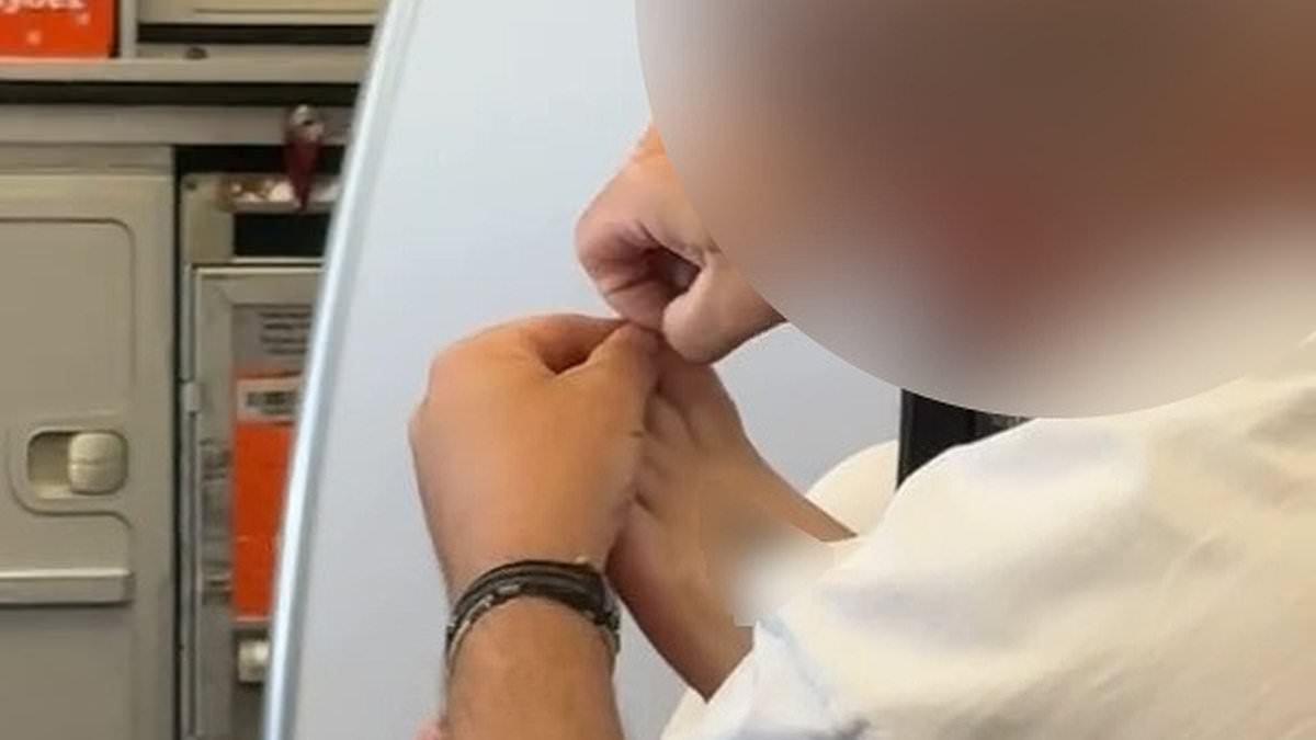 Disgusting moment passenger picks dirt from underneath his partner's TOENAILS on flight from Tenerife