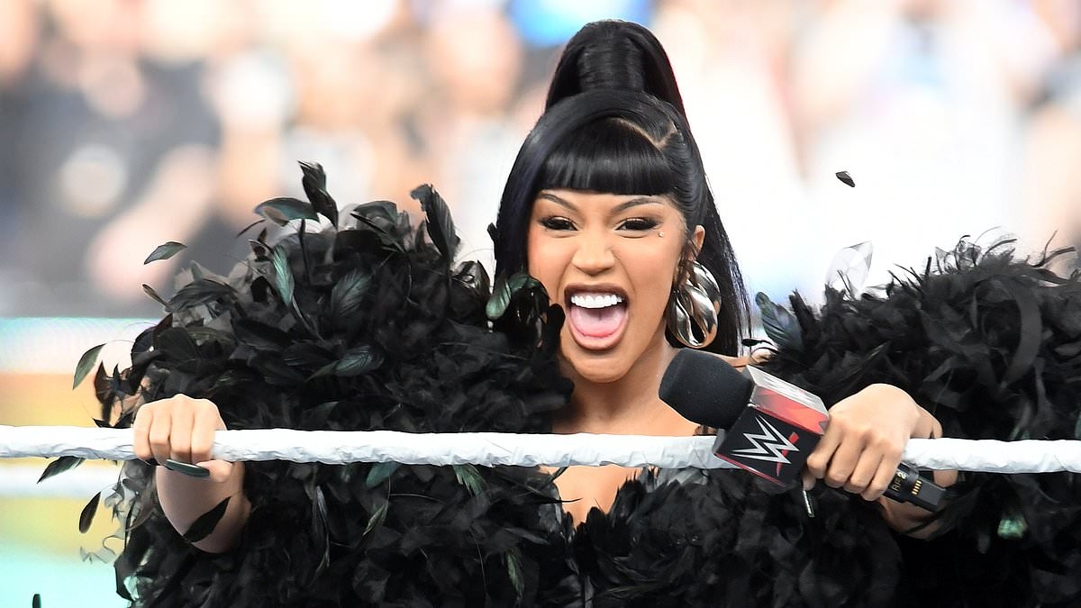 Cardi B wears a dramatic feathered cape and fishnets as she hosts WWE SummerSlam