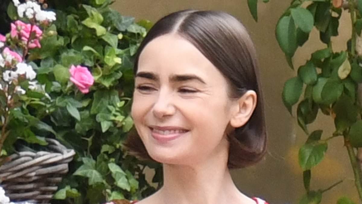 Lily Collins rocks floral print trousers while cradling a huge bouquet of flowers as she continues to film scenes for the fifth season of Emily in Paris