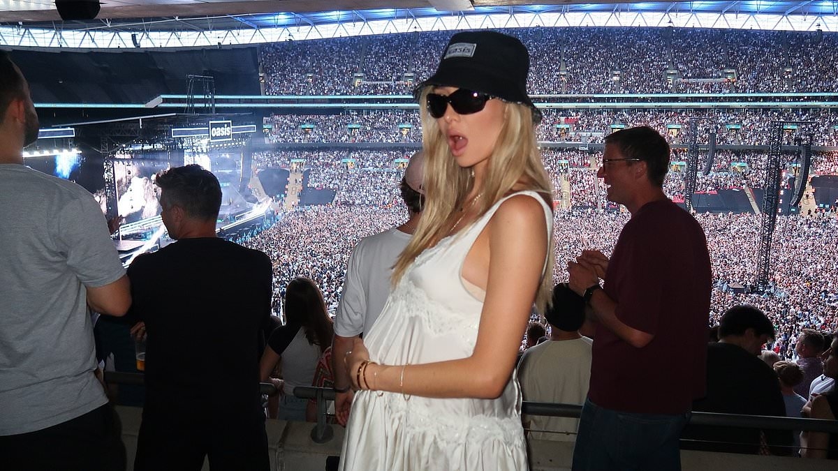 Pregnant Sophie Habboo cradles her growing baby bump in silk minidress as she enjoys night out with Jamie Laing at Oasis gig