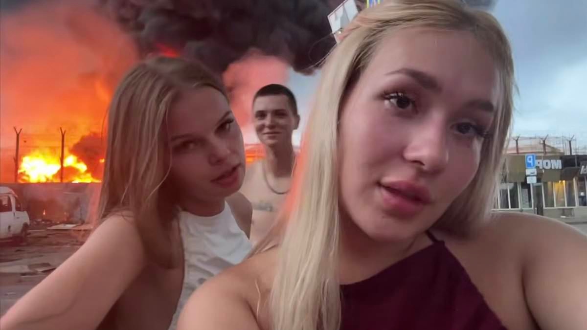 Russian influencers pose for social media video in front of burning oil depot hit by Ukraine strike... and are made to pay the price by Putin's officials