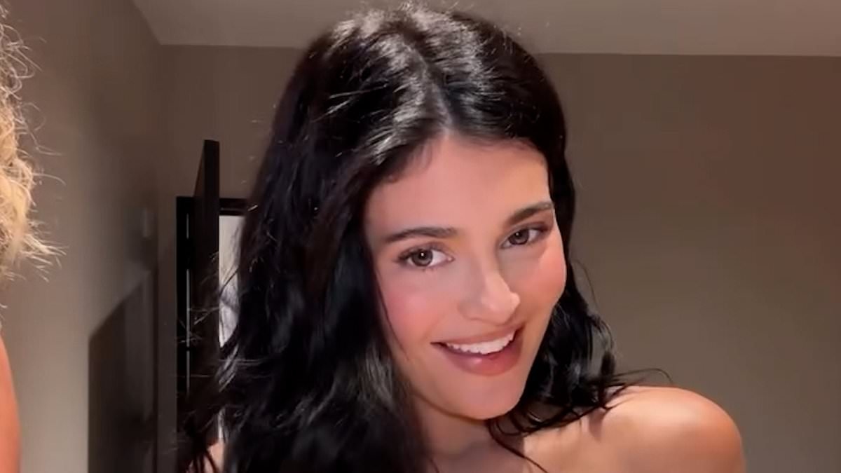 Kylie Jenner nearly spills out of her tiny yellow bra as she reveals she's learning Spanish
