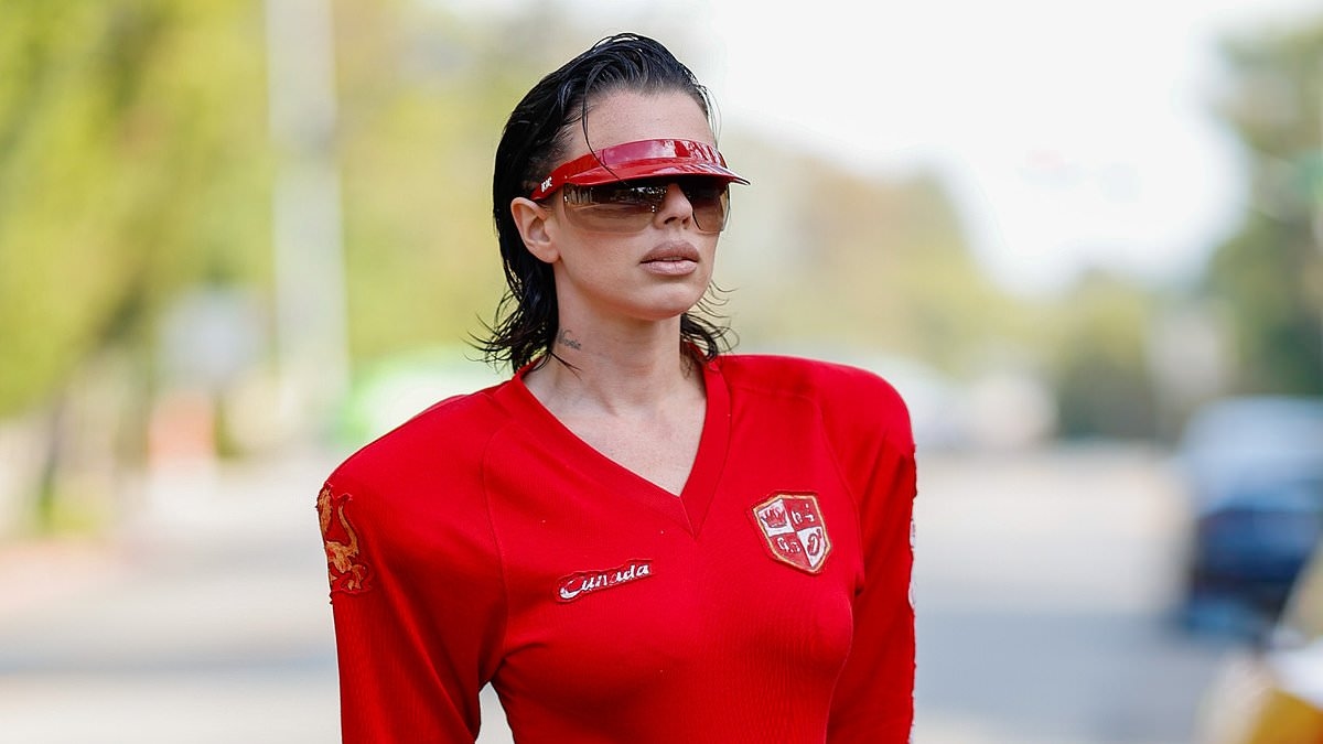 Julia Fox catches the eye in a high-cut American football-inspired leotard and low-slung jeans during solo outing