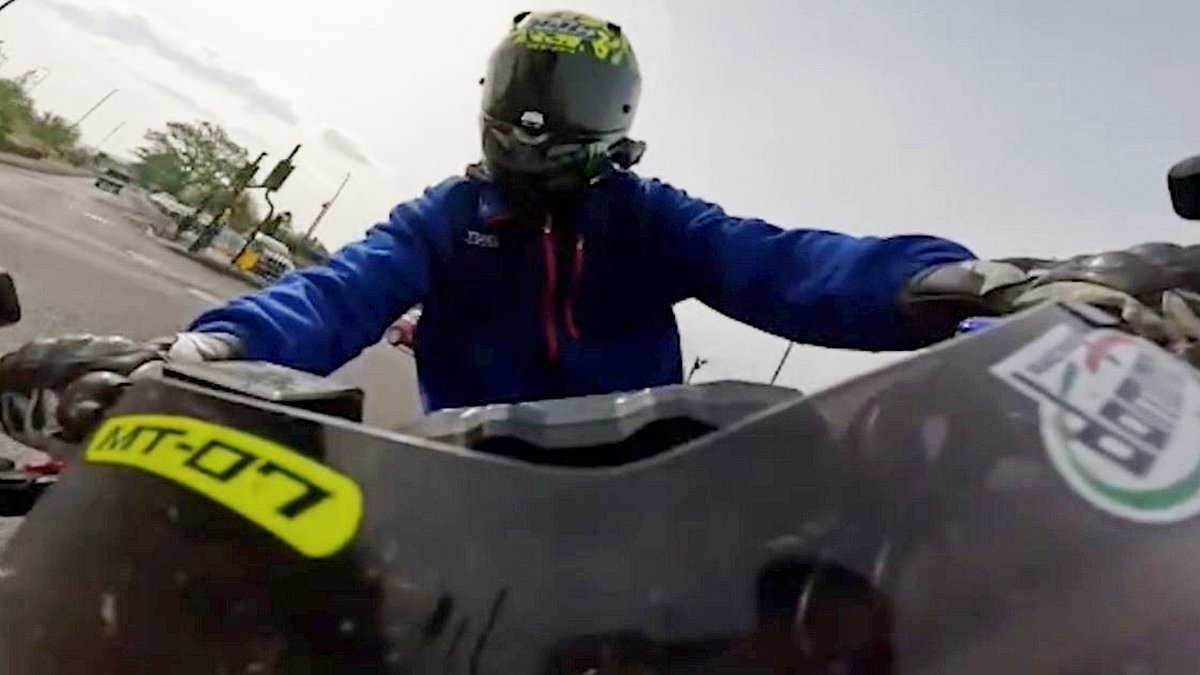 Moment brazen biker who shared 100mph death-defying stunts online avoids death by inches - as he is banned from driving after police spot his videos on social media