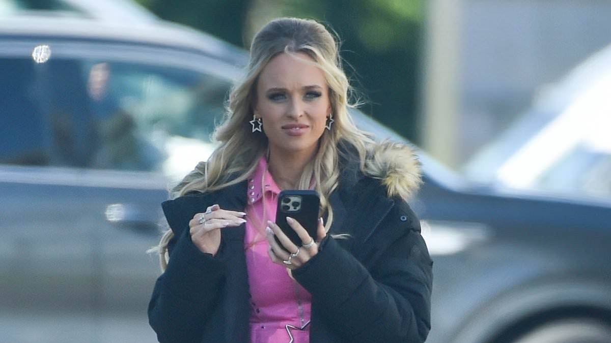 Hollyoaks' Jorgie Porter returns to work following her maternity leave as she flashes her pins in a pink playsuit while filming in Liverpool