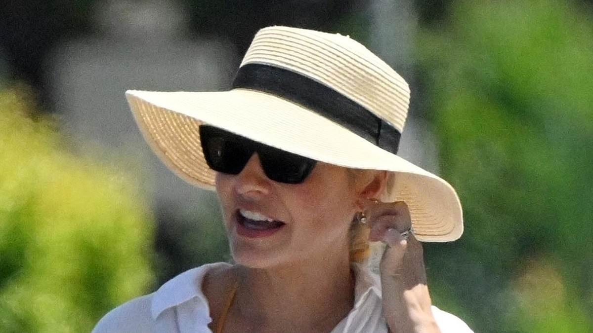 Holly Willoughby flashes her lithe legs in denim hot pants with an airy linen shirt and chic sun hat as she enjoys Portugal getaway