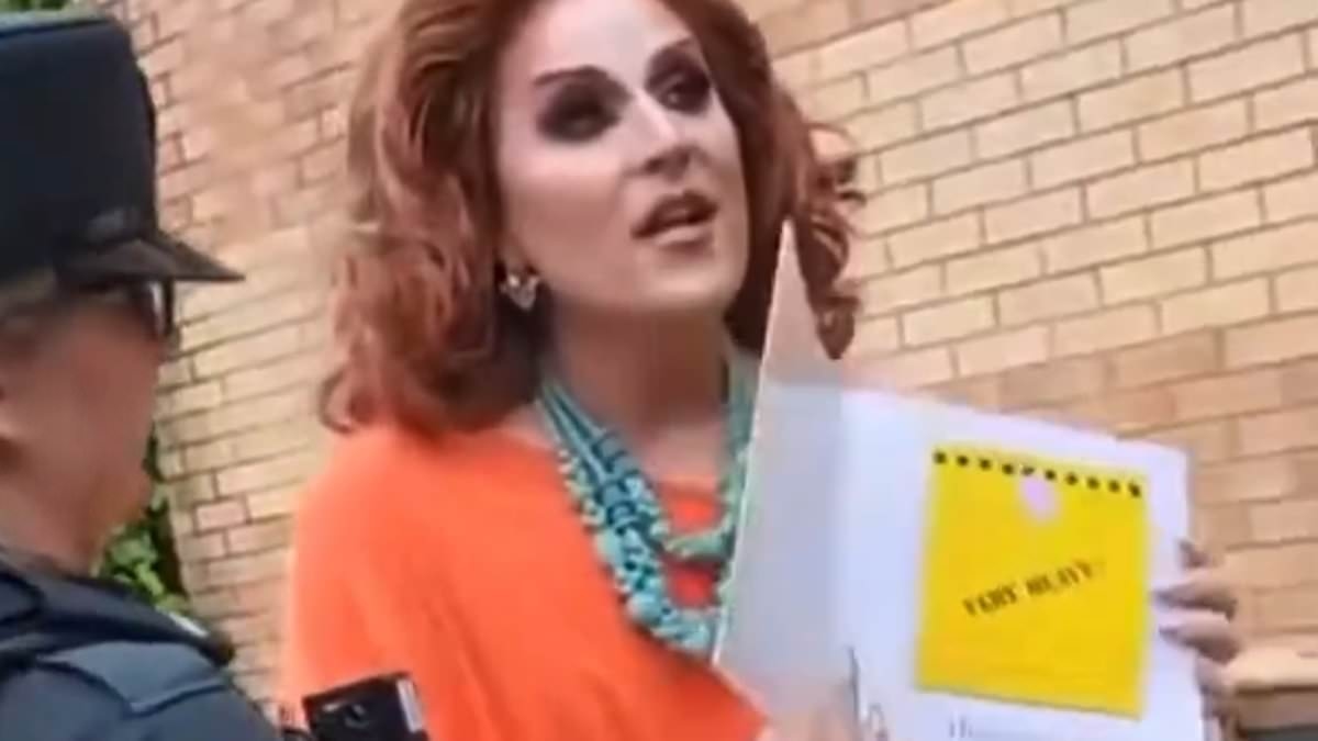 Moment police escorted two drag queens from children's story telling event as angry protesters shouting 'leave our kids alone' confronted them outside