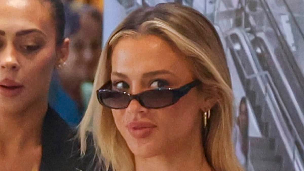 Tammy Hembrow gives an update on her relationship status as she cuts a very casual figure in loose tracksuit at Sydney airport