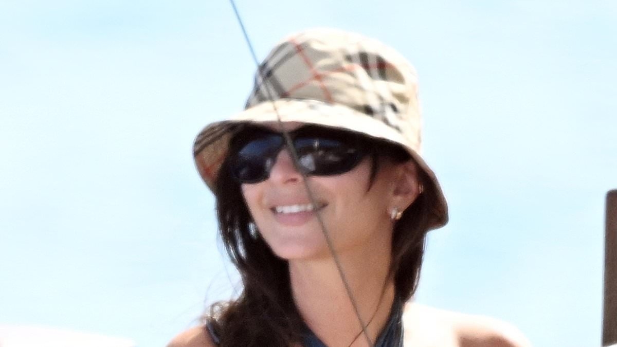 Emily Ratajkowski wows in very cheeky bikini as she dines on fries and beer on boat trip