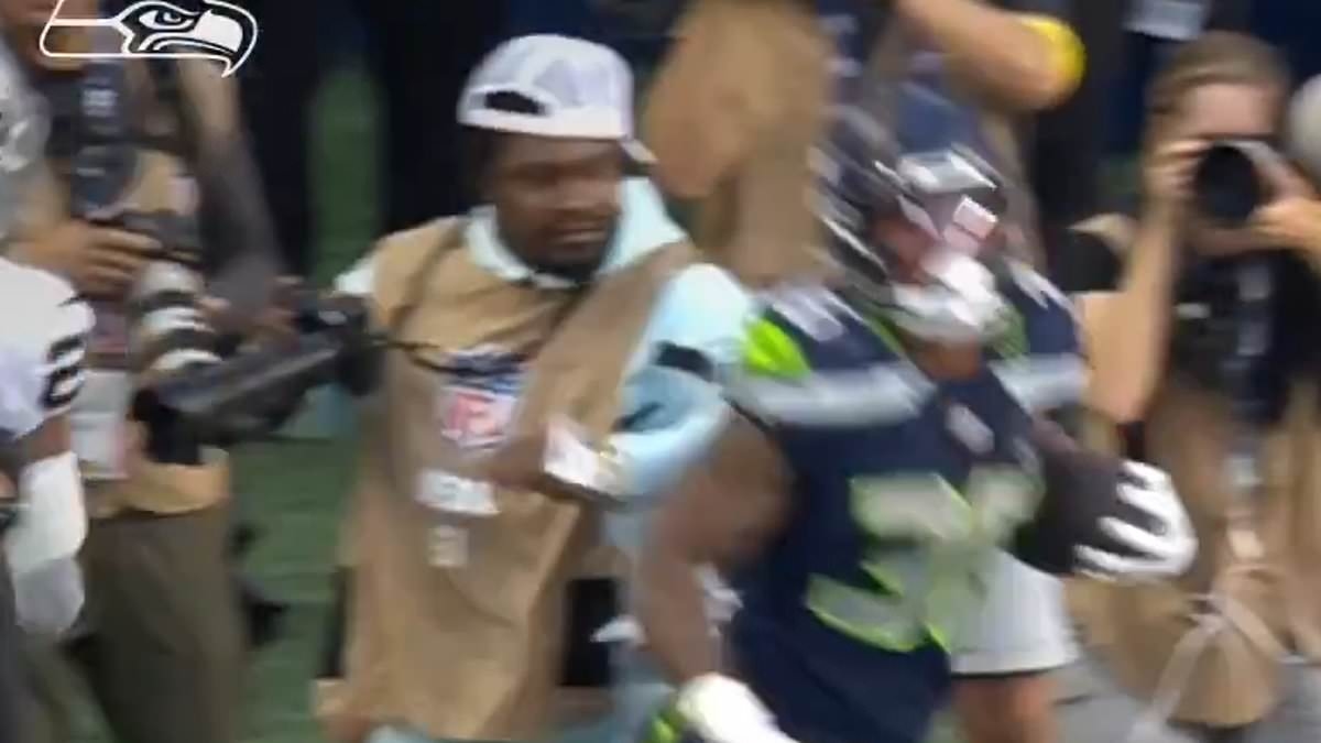 NFL legend Marshawn Lynch throws an elbow at a player while working as a photographer at Seahawks game
