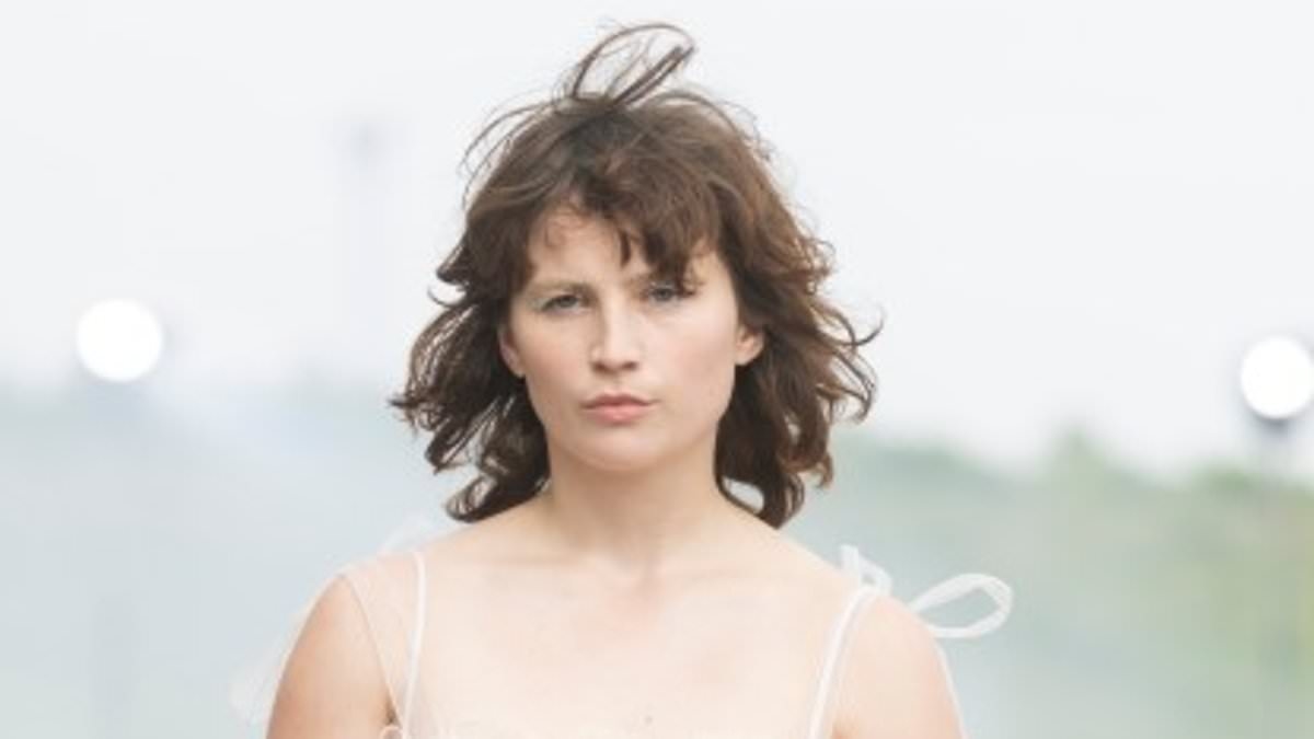Nepo baby, 22, stuns in a semi-sheer white dress as she storms the catwalk during Copenhagen Fashion Week - but can YOU guess who her famous parent is?