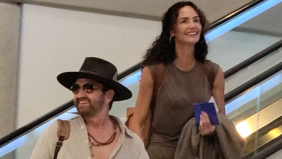 Gerard Butler sparks speculation he wed girlfriend Morgan Brown as he jets out of LA with ring on THAT finger