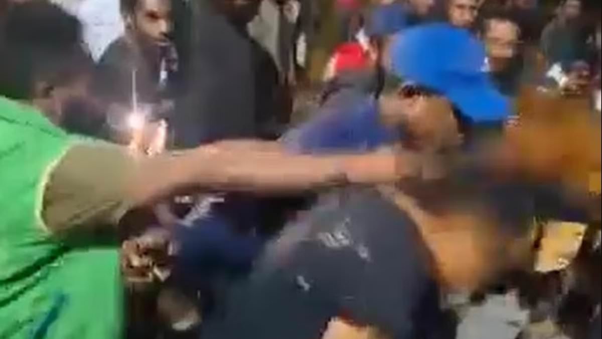 Shameful scenes on Australia's doorstep as jeering male mob chases woman through the grounds of Papua New Guinea uni campus