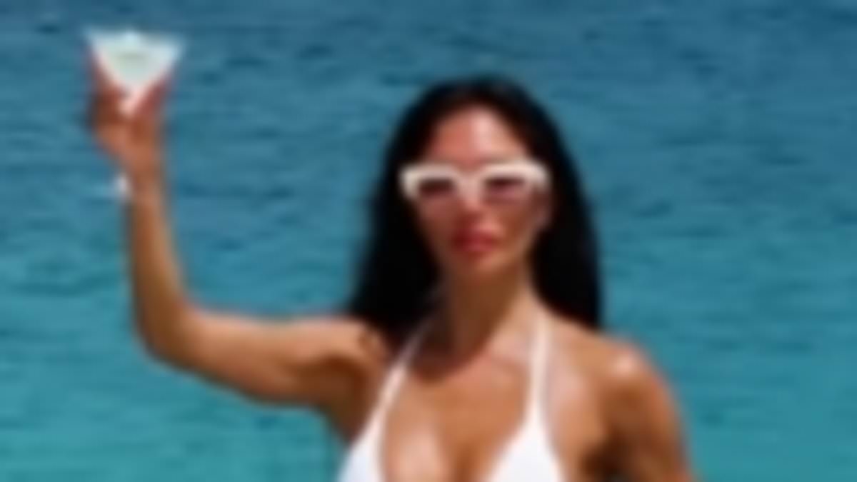 Nicole Scherzinger sets pulses racing as she takes on Nicki Minaj pose challenge in a skimpy white bikini while balancing on a rock and sipping on a martini