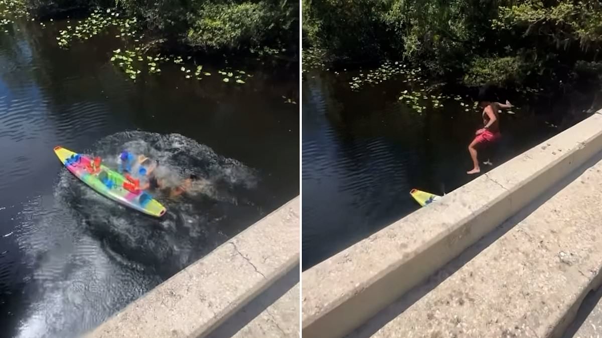 Moment daredevil leaps off bridge to dive into water before crash-landing on group of kayakers below