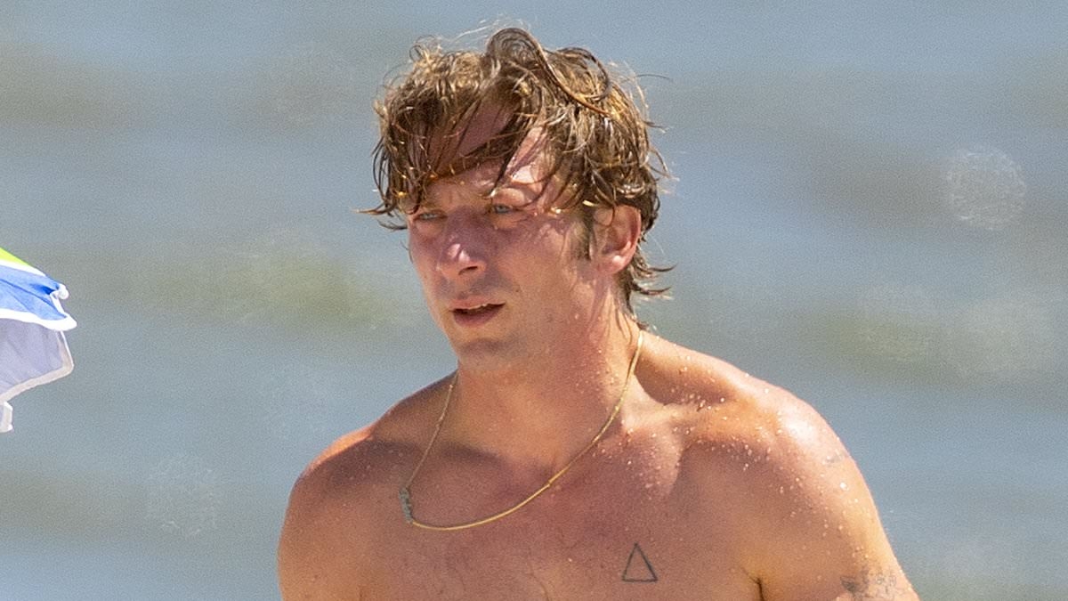 Jeremy Allen White displays his chiseled physique as he cools off on the beach