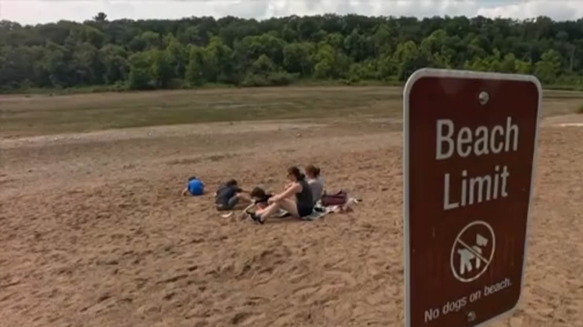 Lake mysteriously vanishes and leaves confused kids playing in the dry sand