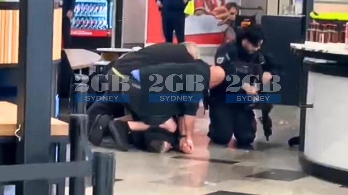 Sydney Airport is plunged into lockdown after 'gun was fired in terminal' - as video emerges of dramatic arrest