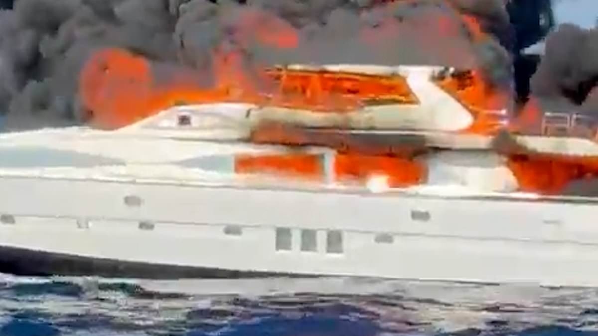 Moment yacht bursts into flames at sea before sinking