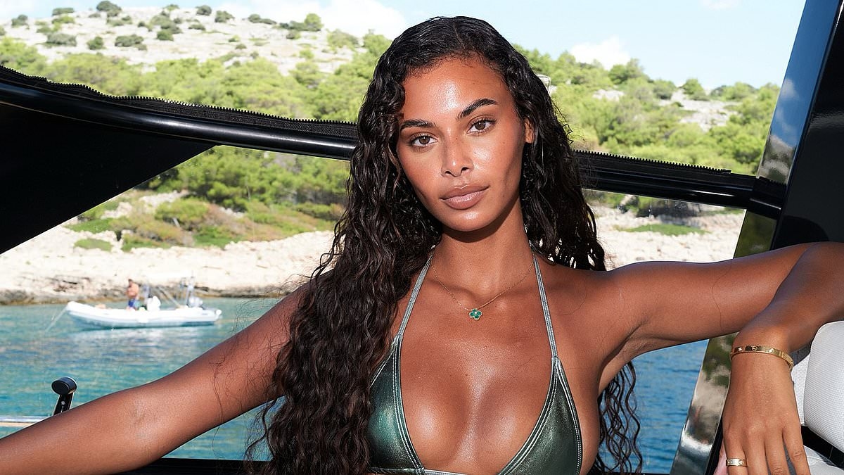 Love Island's Sophie Piper sends temperatures soaring as she puts on a busty display in a skimpy green bikini during boat trip