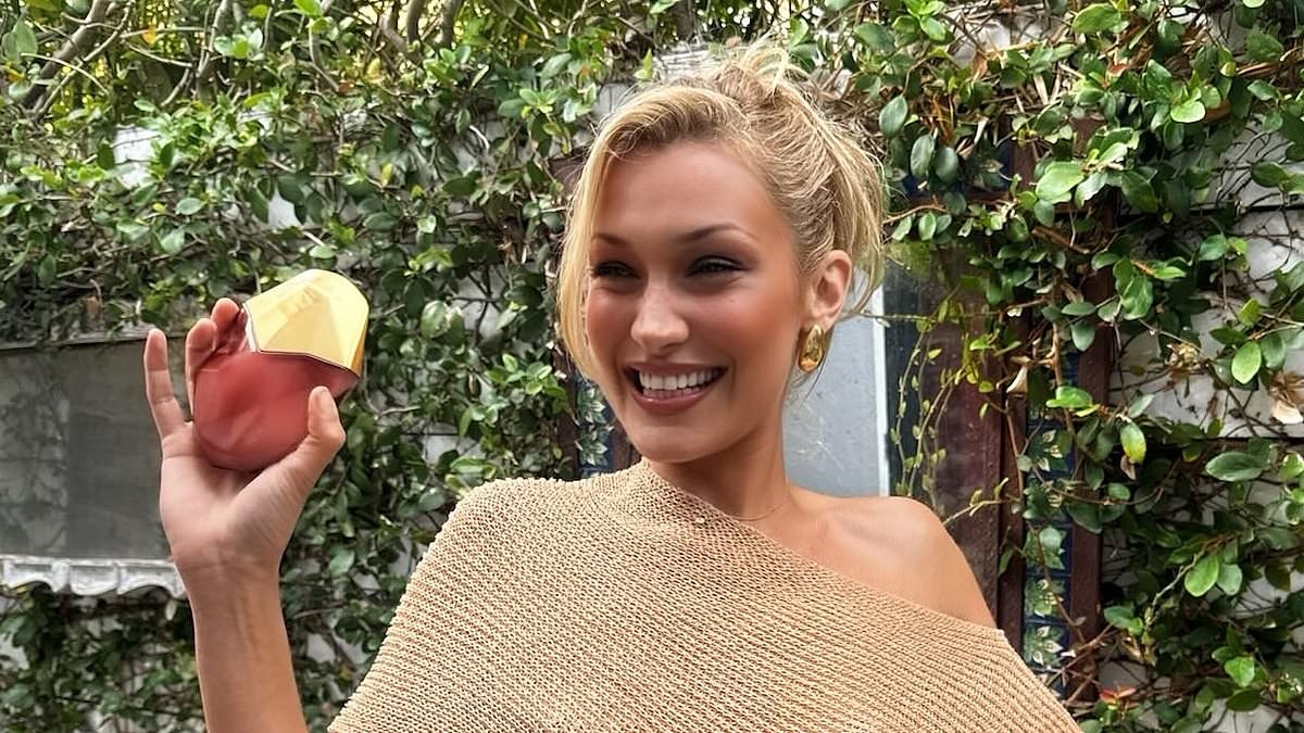 Bella Hadid goes braless under a semi-sheer cropped shawl as she launches latest perfume