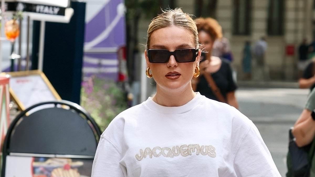 Perrie Edwards keeps it casual in stylish white oversized T-shirt and jeans while leaving Heart FM studios